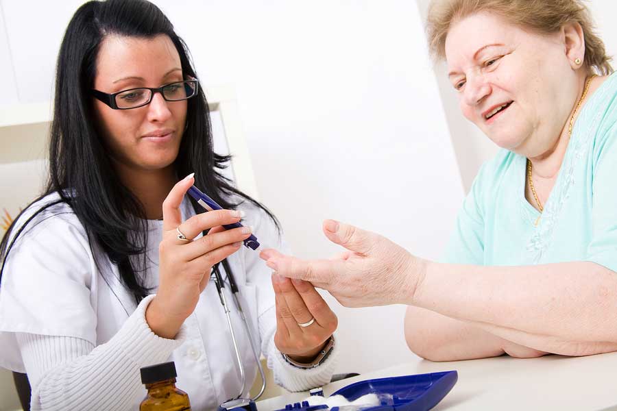 Doctor performing blood check on diabetes patient